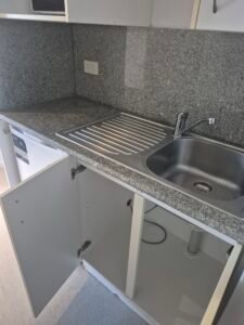 Spotless kitchen benchtop and sink after professional cleaning