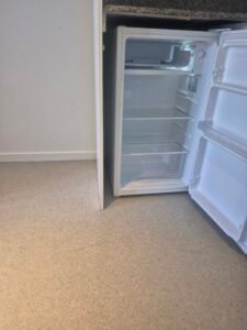 Cleaned kitchen with empty fridge ready for inspection