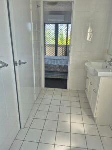 Bright clean bathroom with vanity and window