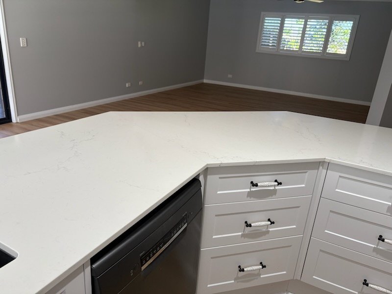Kitchen benchtop with open-plan living area cleaned